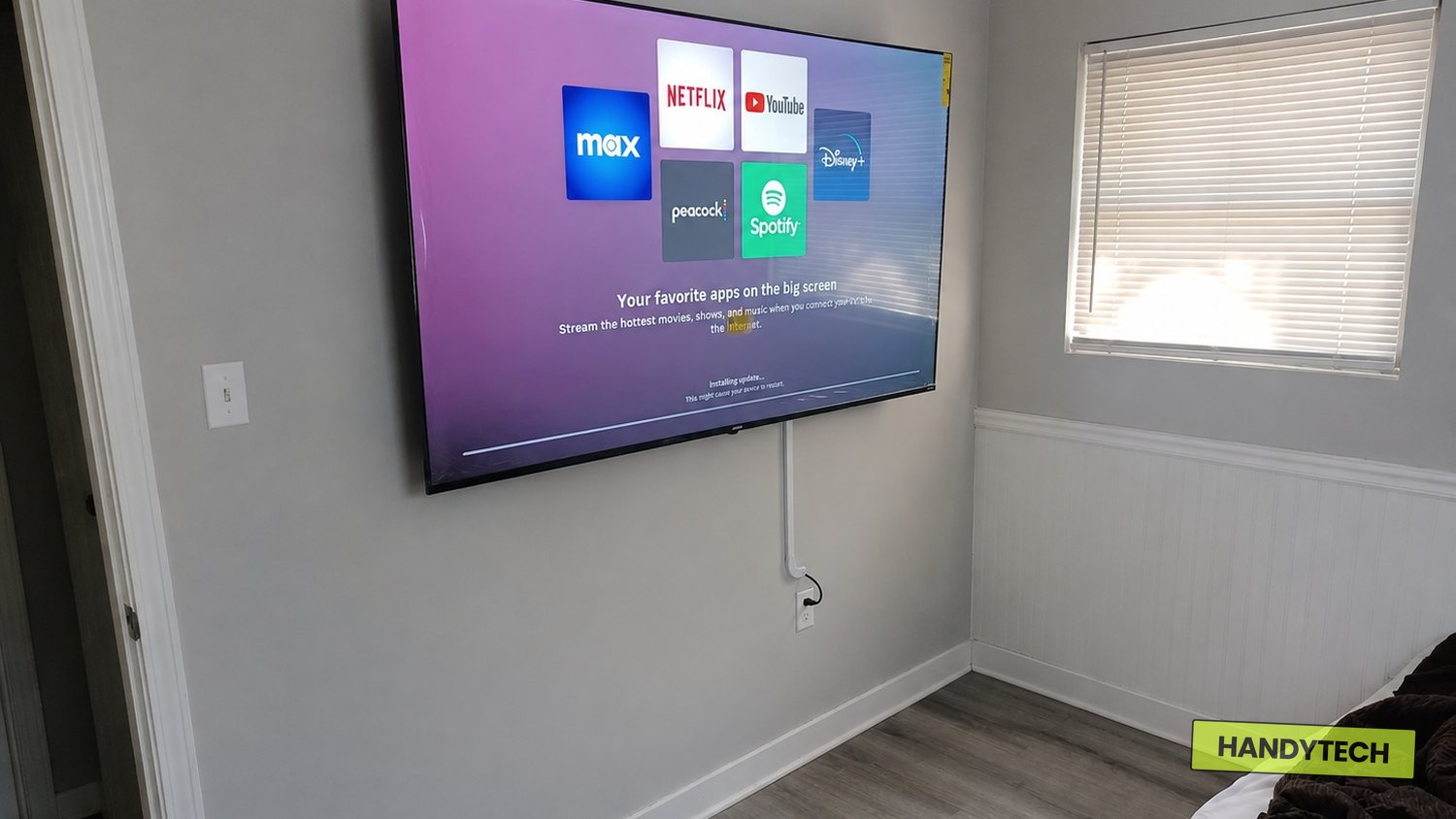 75 inch TV mounted on a drywall bedroom wall in Hattiesburg MS with cord management